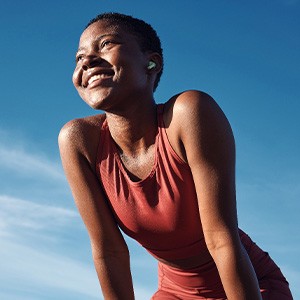 Woman smiling while exercising outside