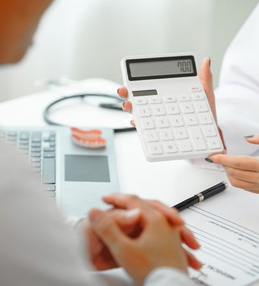 A dentist discussing treatment prices with a patient