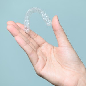 Patient holding clear aligner