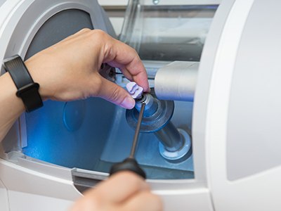 a dentist pointing to a digital impression of teeth on a screen