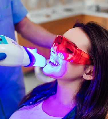 a person getting their teeth whitened