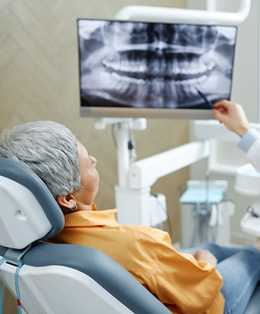 Dentist going over the full mouth reconstruction process with patient