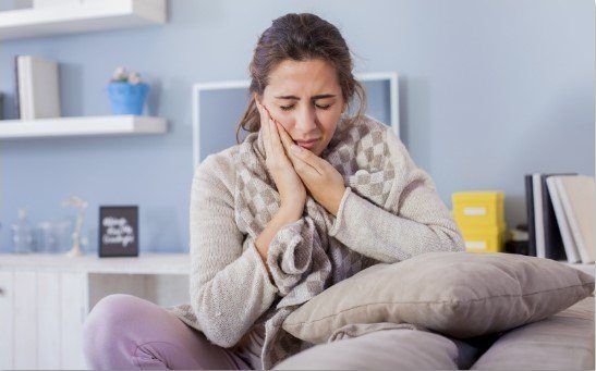 woman holding mouth in pain in Alpharetta