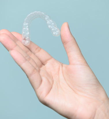 Patient holding clear aligner
