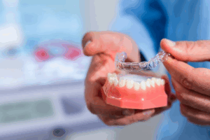 Dentist removing a SureSmile tray from a dental model
