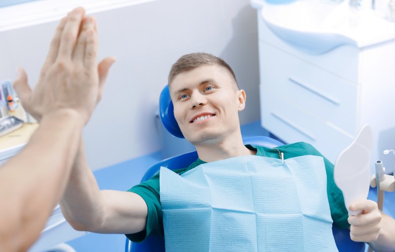 Patient smiling with dentist after root canal
